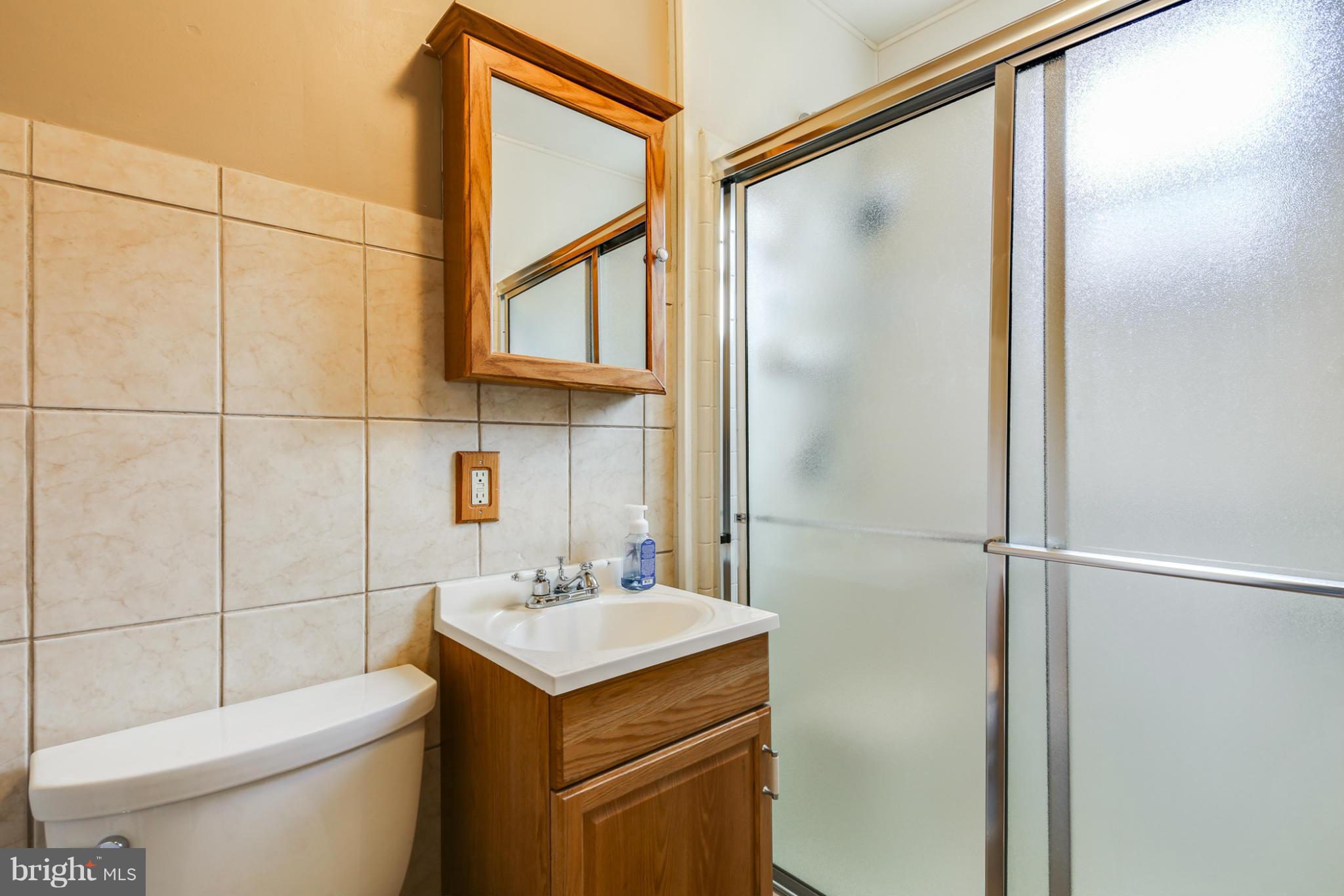 4117 Old Washington Road Baltimore, MD 21227 - Photo 13 of 27 a bathroom with a sink a toilet and shower