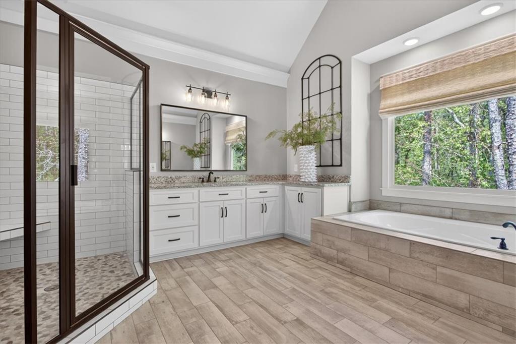 122 Brookfield Court White, GA 30184 - Photo 24 of 63 a spacious bathroom with a granite countertop sink mirror and a shower