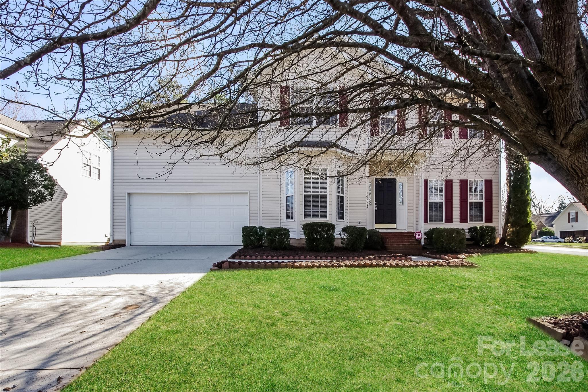 10802 Gold Pan Road Charlotte, NC 28215 - Photo 1 of 15 a front view of a house with a yard and garage