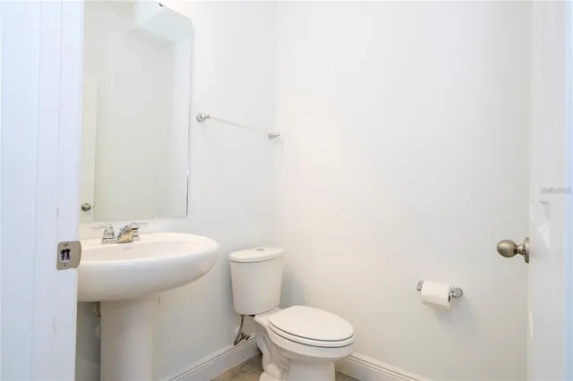 a bathroom with a sink mirror and toilet