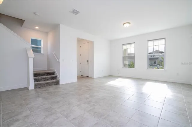 an empty room with windows and closet