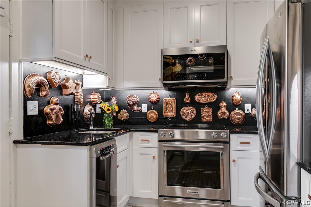 5621 Cary Street Road, Unit U206 Richmond, VA 23226 - Photo 13 of 34 a kitchen with stainless steel appliances granite countertop a stove and a refrigerator