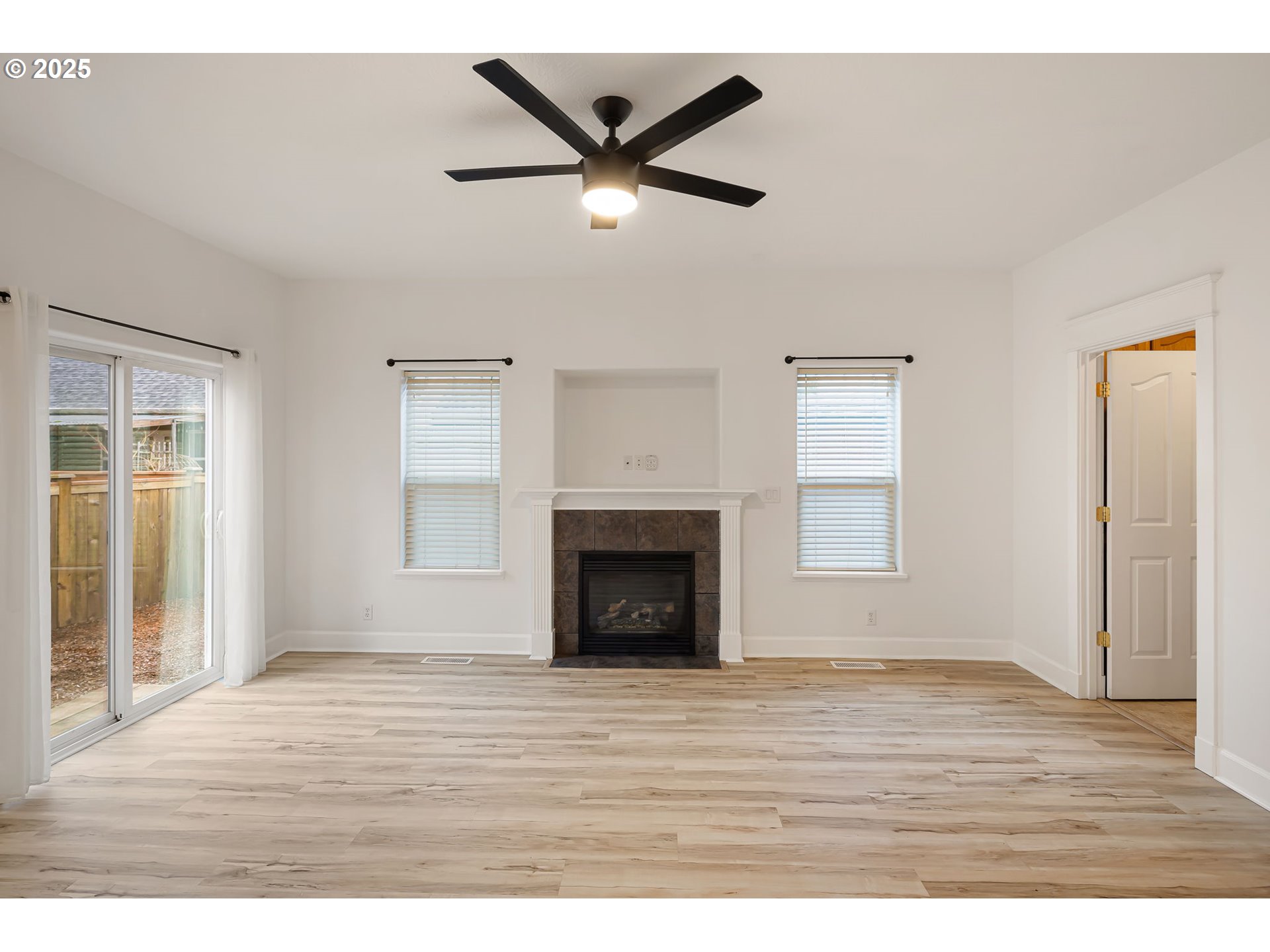 6808 Moses Pass Springfield, OR 97478 - Photo 15 of 37 a view of an empty room with wooden floor and a window