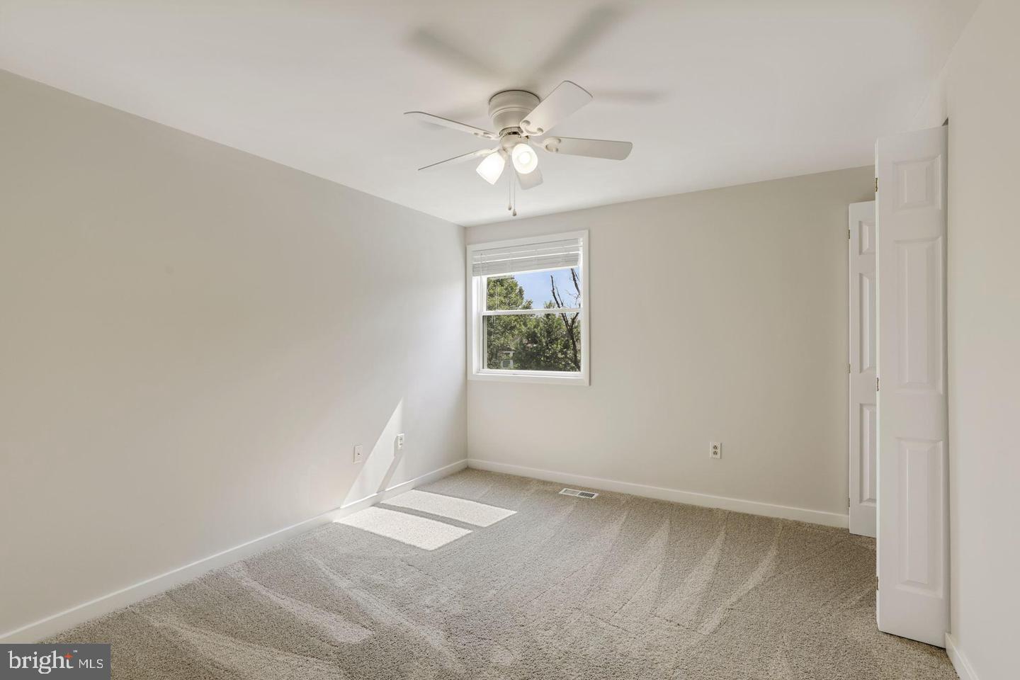 6372 Shadowshape Place Columbia, MD 21045 - Photo 23 of 36 an empty room with a window and a fan