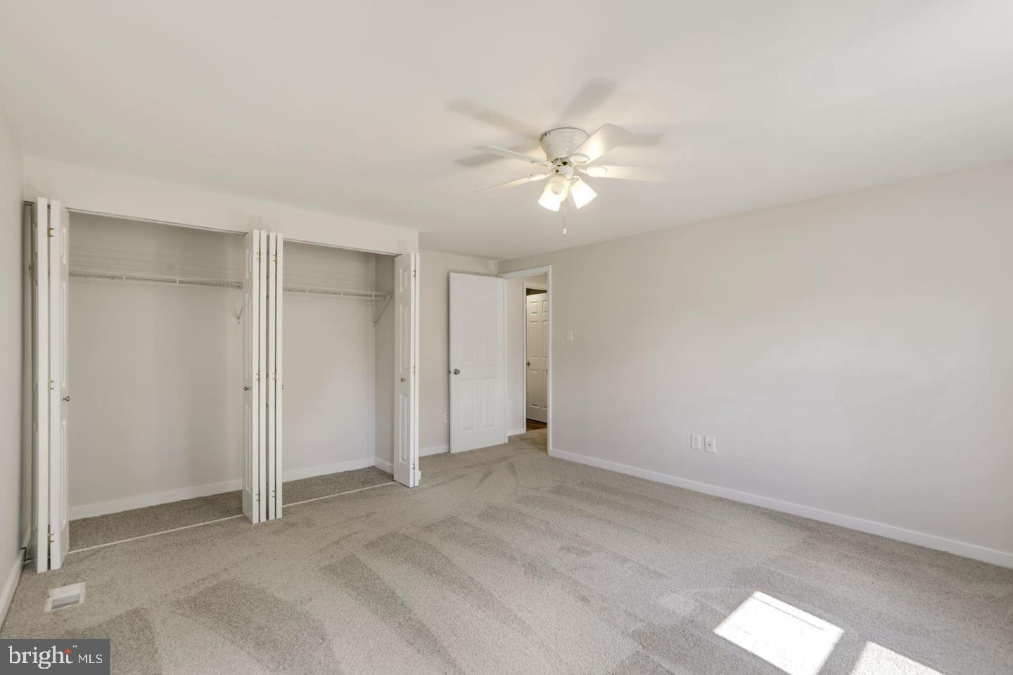 6372 Shadowshape Place Columbia, MD 21045 - Photo 27 of 36 an empty room with a ceiling fan and a window