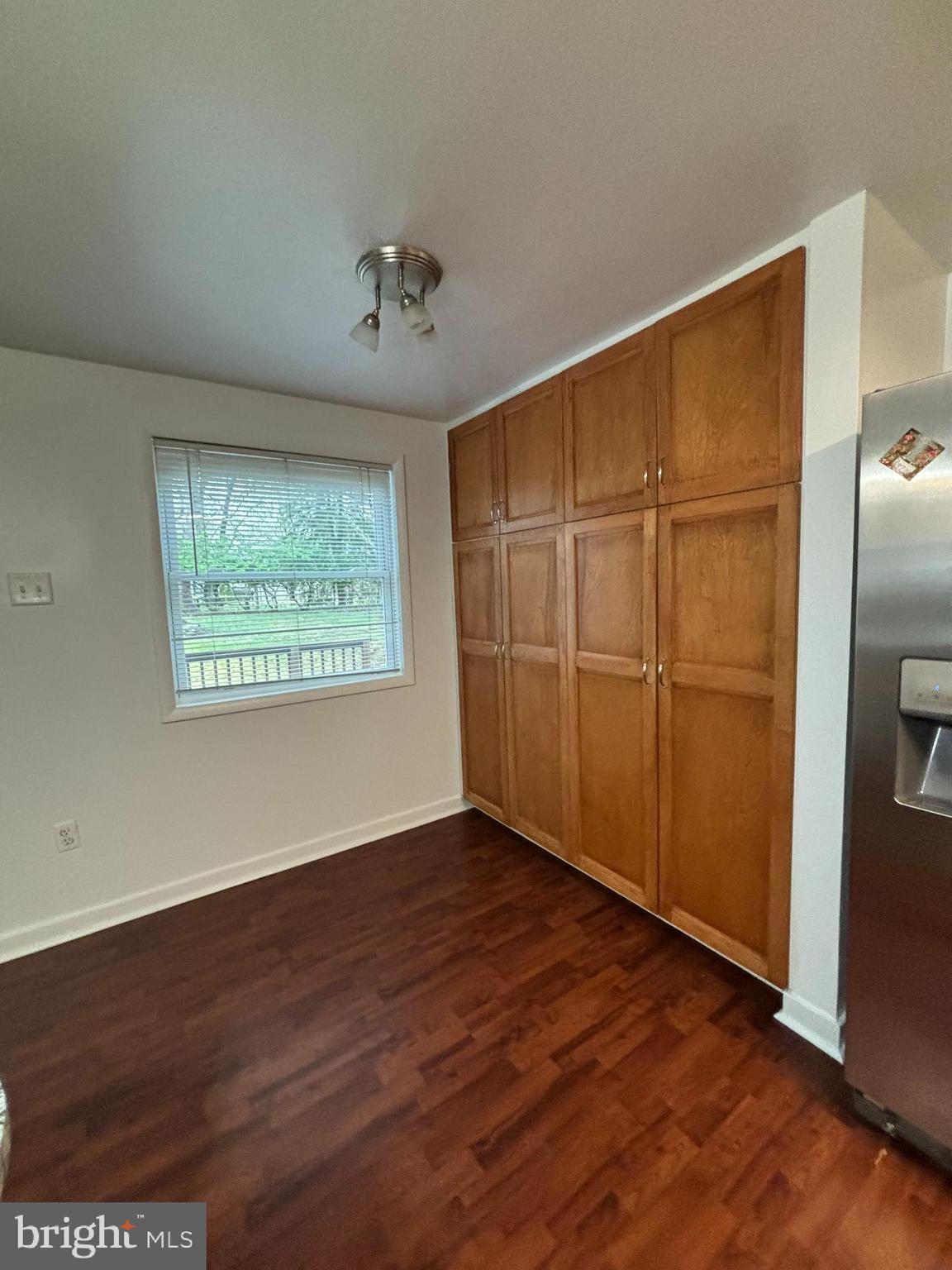 6372 Shadowshape Place Columbia, MD 21045 - Photo 6 of 36 an empty room with wooden floor closet and windows