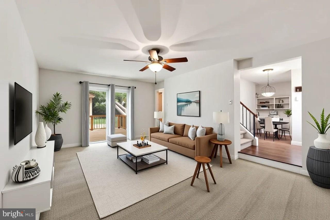 6372 Shadowshape Place Columbia, MD 21045 - Photo 10 of 36 a living room with furniture a flat screen tv and a large window