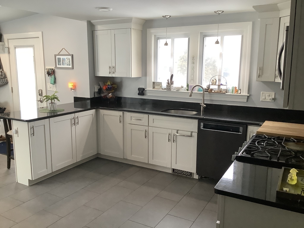 2 Chapel Road Danvers, MA 01923 - Photo 3 of 15 a kitchen with granite countertop a sink stove and cabinets