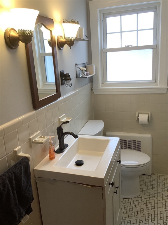 2 Chapel Road Danvers, MA 01923 - Photo 9 of 15 a bathroom with a sink toilet and mirror