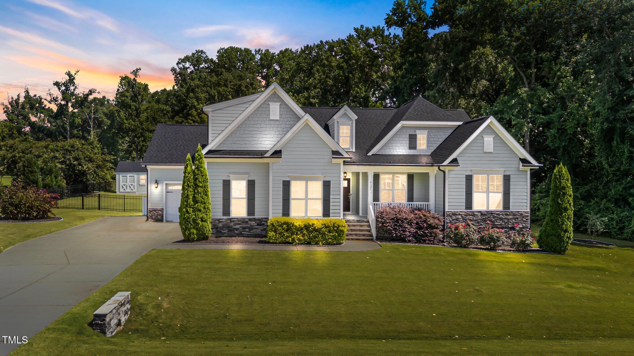 4125 Olde Judd Drive Willow Spring, NC 27592 - Photo 1 of 48 a front view of a house with garden