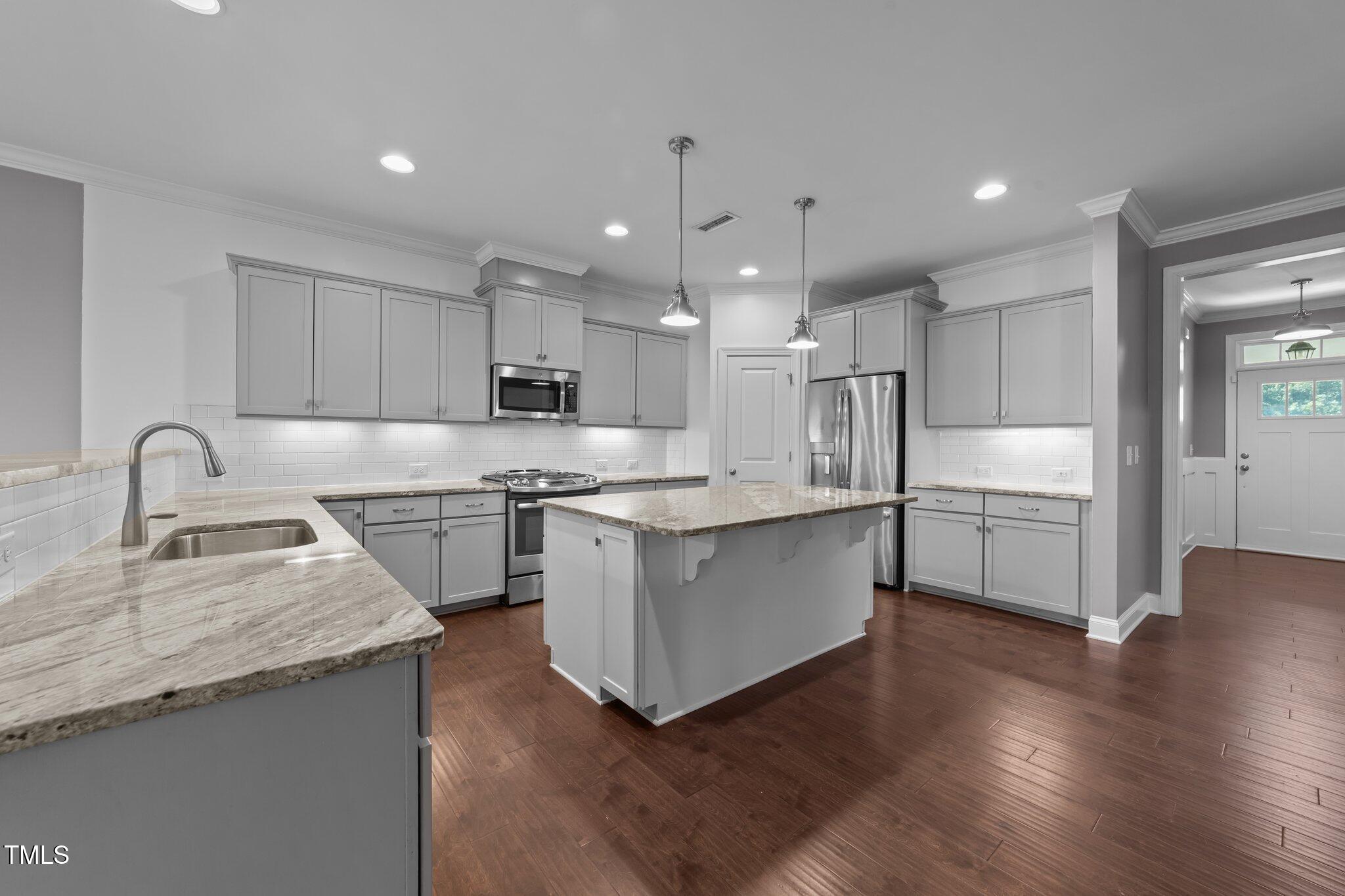 4125 Olde Judd Drive Willow Spring, NC 27592 - Photo 12 of 48 a kitchen with white cabinets and appliances