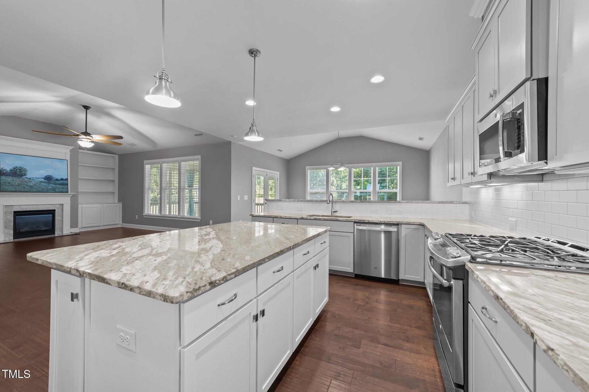 4125 Olde Judd Drive Willow Spring, NC 27592 - Photo 13 of 48 a kitchen with granite countertop sink stainless steel appliances and window