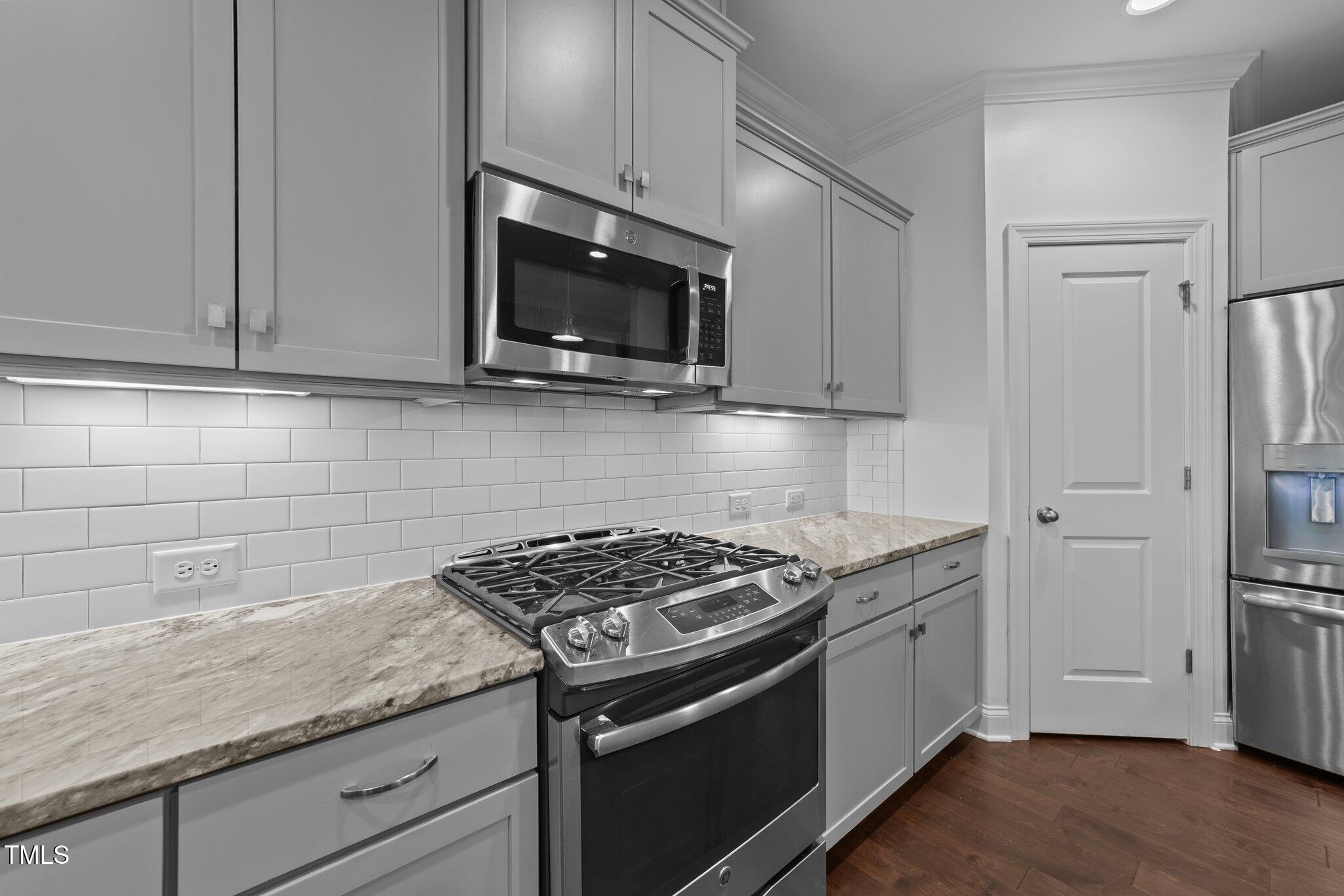 4125 Olde Judd Drive Willow Spring, NC 27592 - Photo 14 of 48 a kitchen with stainless steel appliances granite countertop a sink stove and microwave