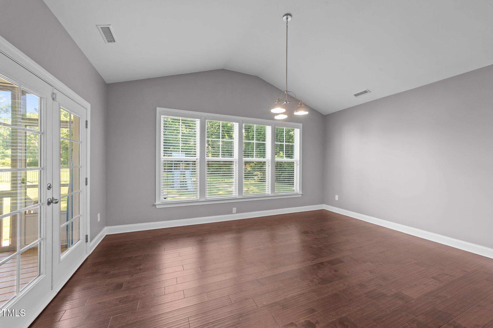 4125 Olde Judd Drive Willow Spring, NC 27592 - Photo 16 of 48 an empty room with wooden floor and windows