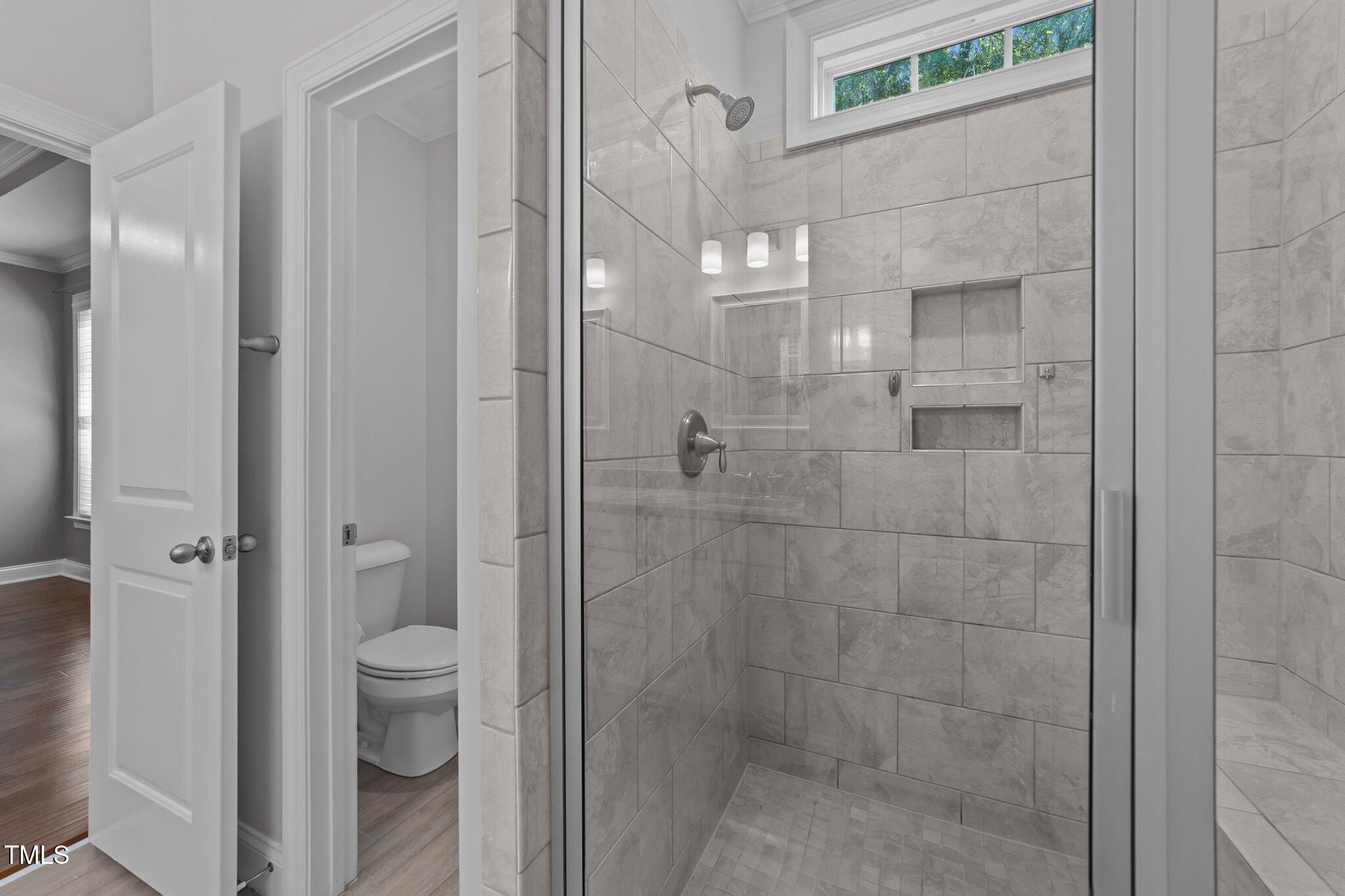 4125 Olde Judd Drive Willow Spring, NC 27592 - Photo 22 of 48 a bathroom with a glass shower door