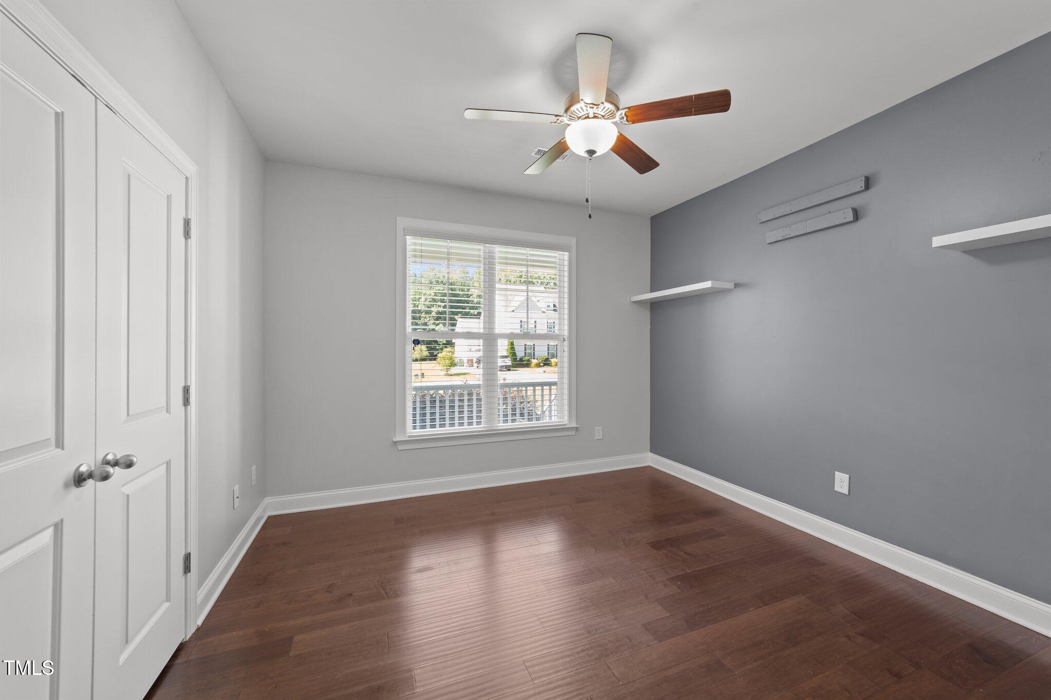 4125 Olde Judd Drive Willow Spring, NC 27592 - Photo 25 of 48 an empty room with wooden floor fan and windows