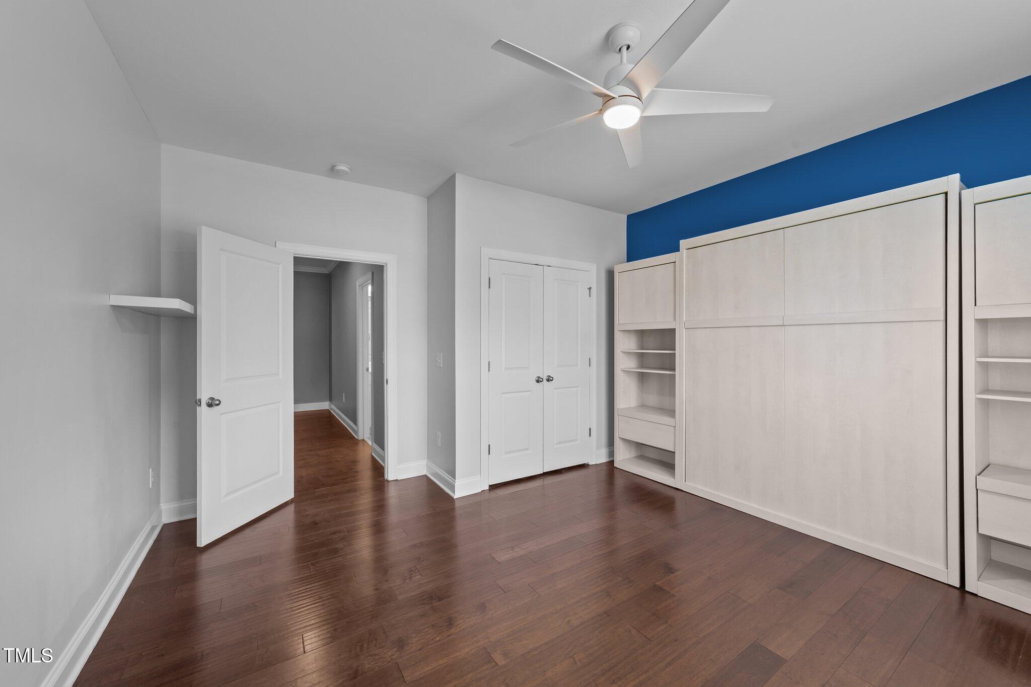 4125 Olde Judd Drive Willow Spring, NC 27592 - Photo 30 of 48 an empty room with wooden floor and a ceiling fan