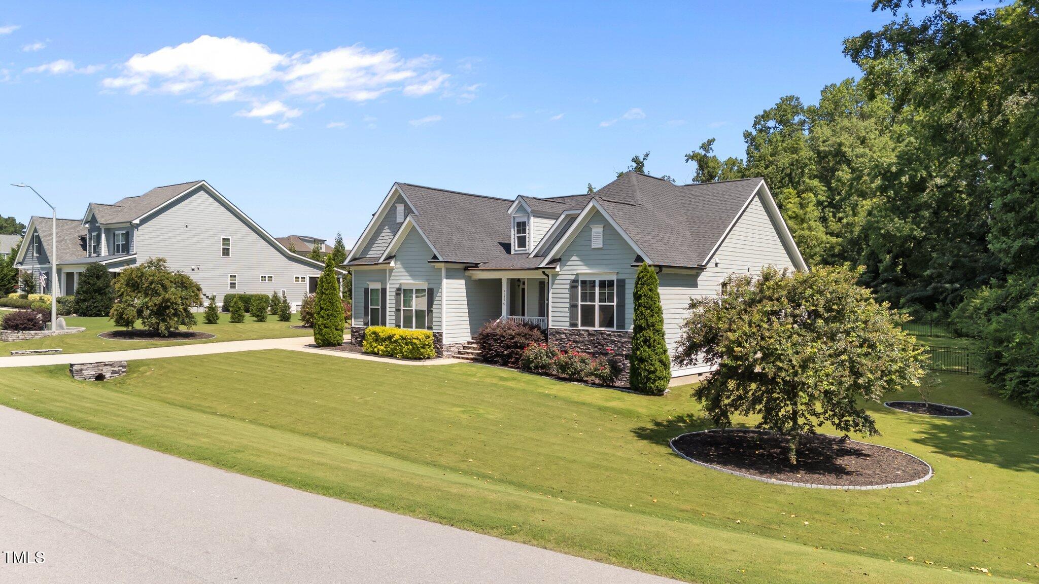 4125 Olde Judd Drive Willow Spring, NC 27592 - Photo 3 of 48 a front view of a house with swimming pool yard and outdoor seating
