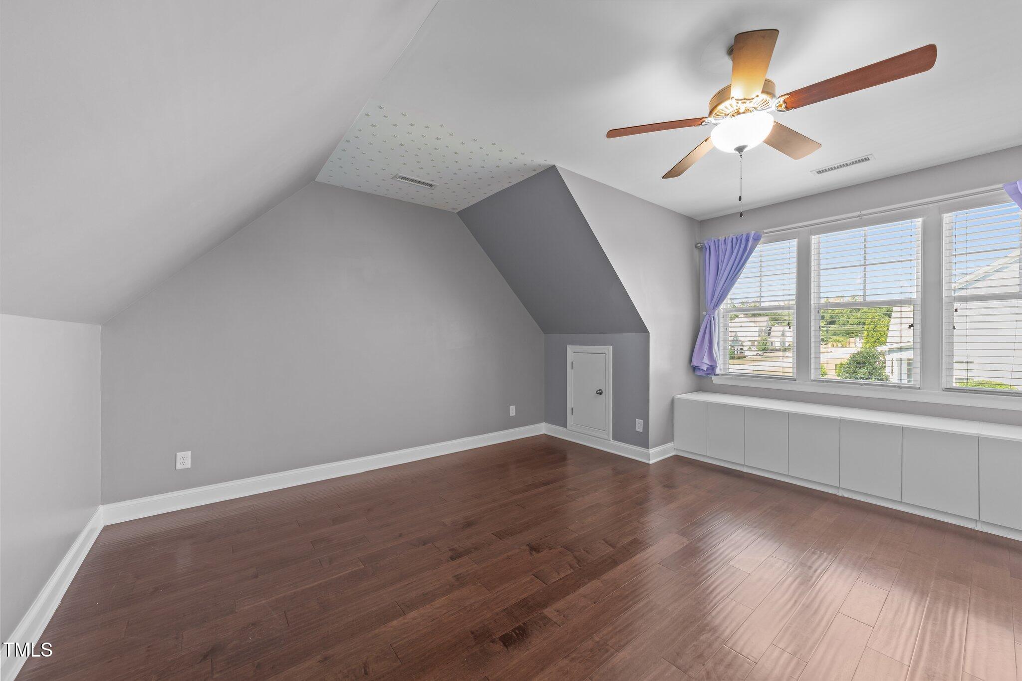 4125 Olde Judd Drive Willow Spring, NC 27592 - Photo 33 of 48 an empty room with wooden floor chandelier fan and windows