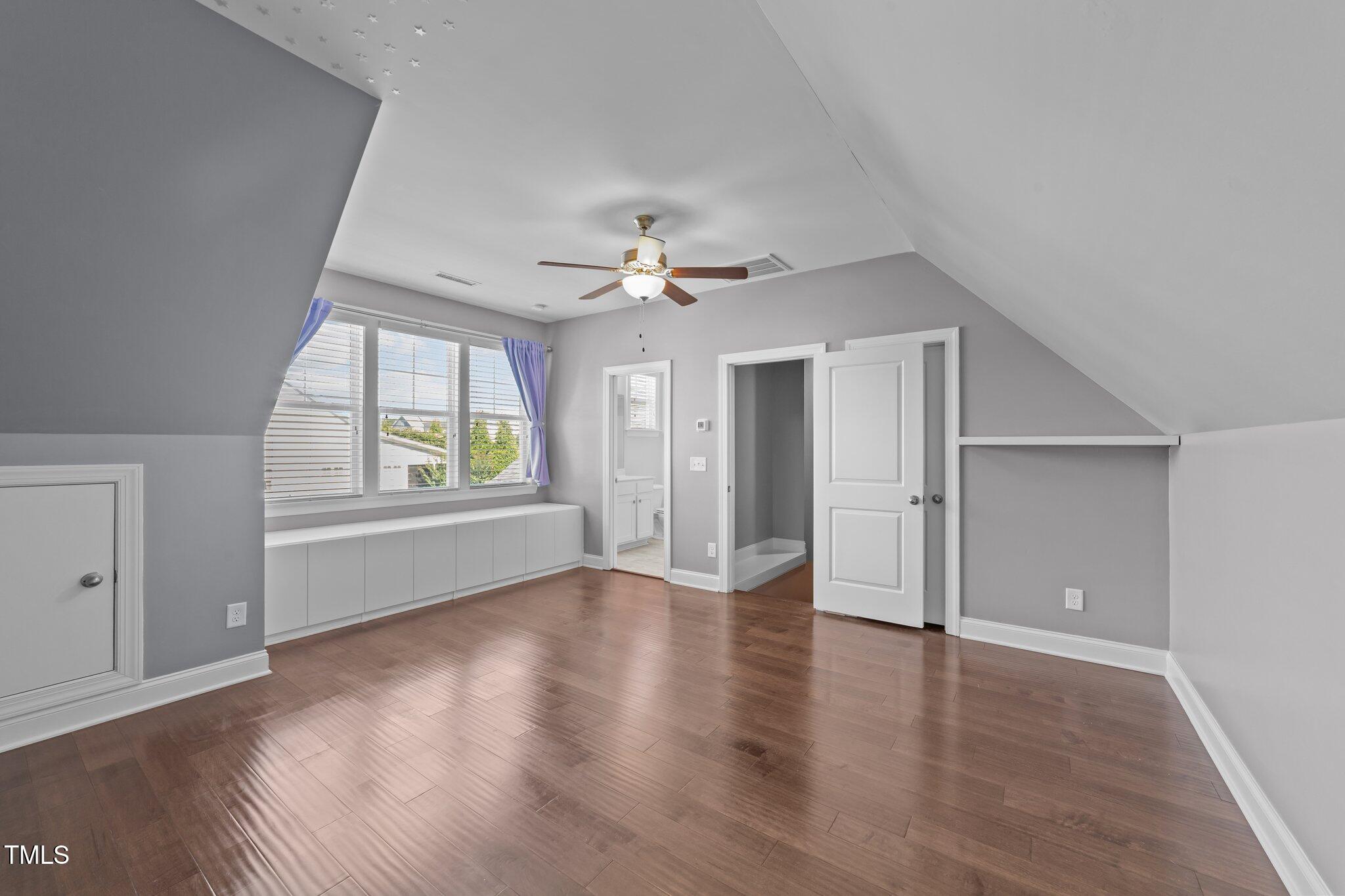 4125 Olde Judd Drive Willow Spring, NC 27592 - Photo 34 of 48 an empty room with wooden floor chandelier and windows