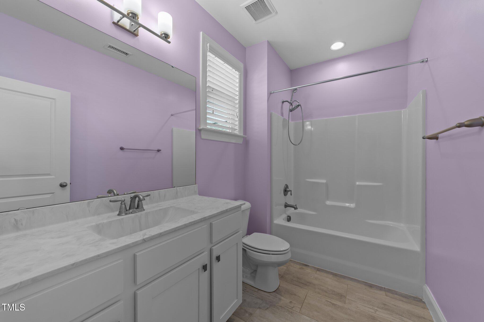 4125 Olde Judd Drive Willow Spring, NC 27592 - Photo 35 of 48 a bathroom with a sink a toilet a mirror and shower