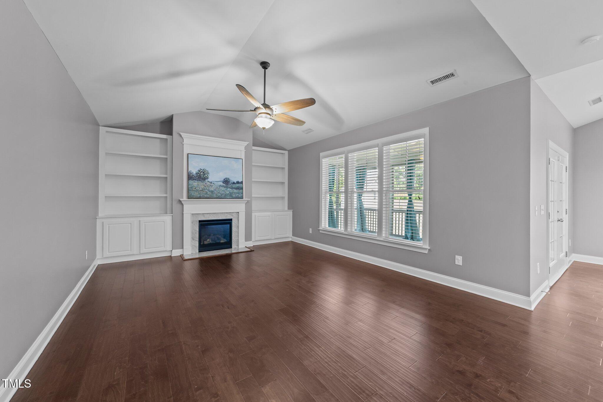 4125 Olde Judd Drive Willow Spring, NC 27592 - Photo 8 of 48 a view of an empty room with wooden floor fireplace and a window