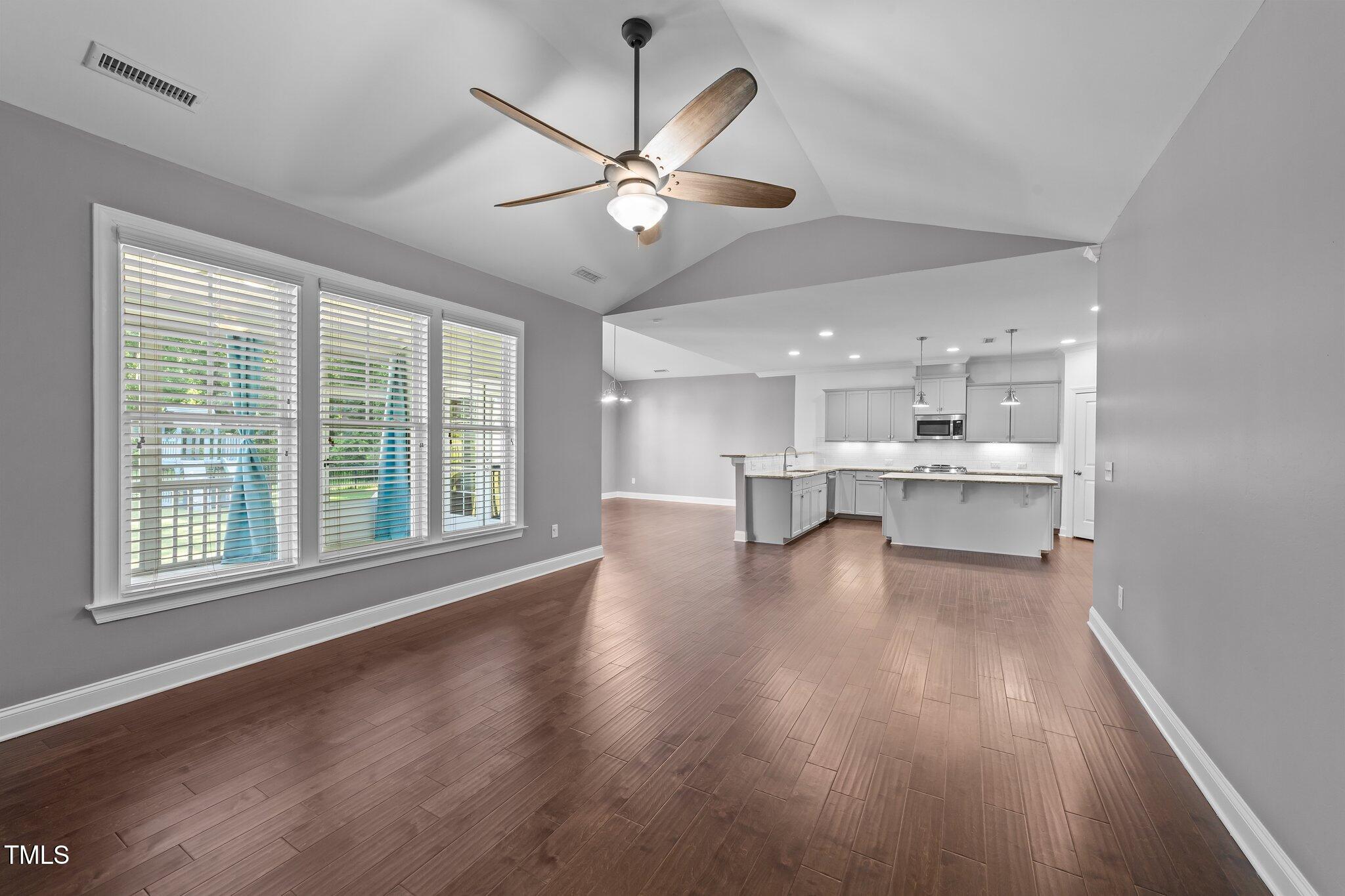4125 Olde Judd Drive Willow Spring, NC 27592 - Photo 10 of 48 a view of an empty room with a window and wooden floor