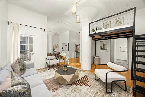 a living room with furniture a rug and a window