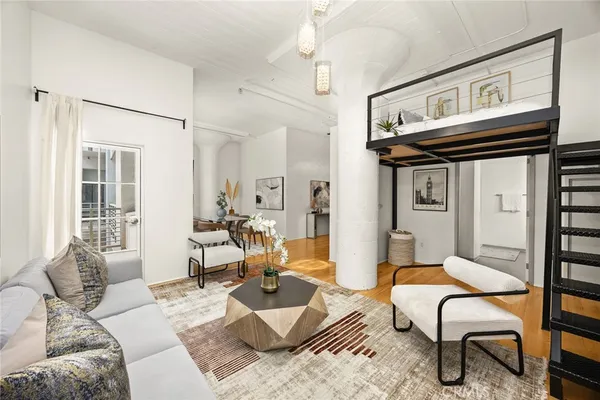 a living room with furniture a rug and a window