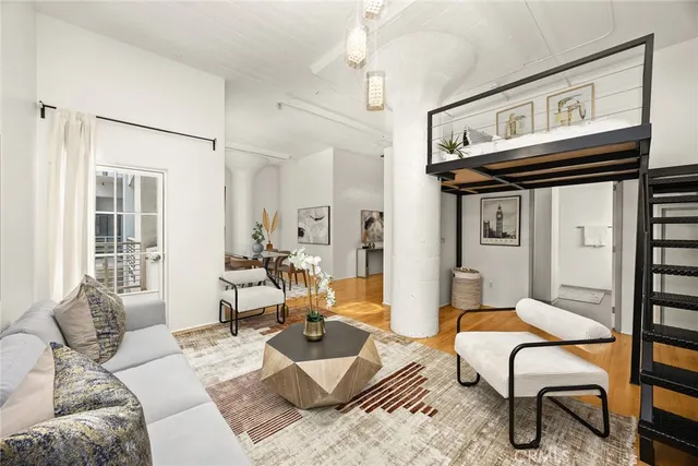 a living room with furniture a rug and a window