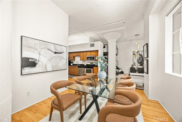a dining room with furniture and a painting on the wall