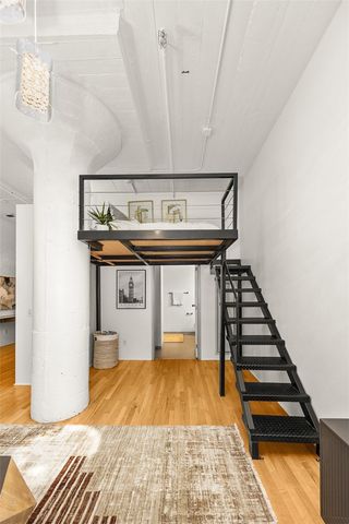 a very nice looking room with wooden floor and furniture