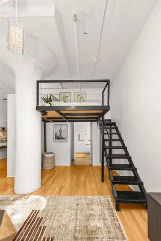 a very nice looking room with wooden floor and furniture