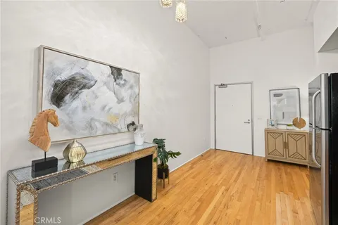 a view of a kitchen with sink and wooden floor