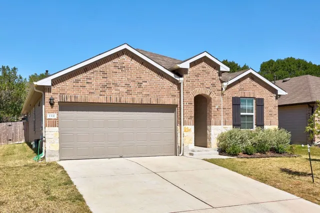 a view of a house with a yard and garage