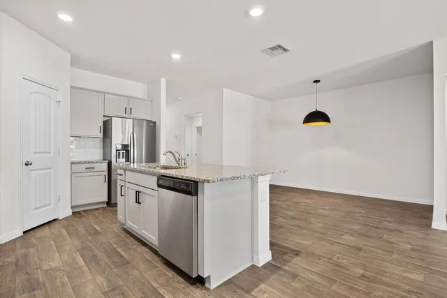 a kitchen with stainless steel appliances a sink stove and microwave