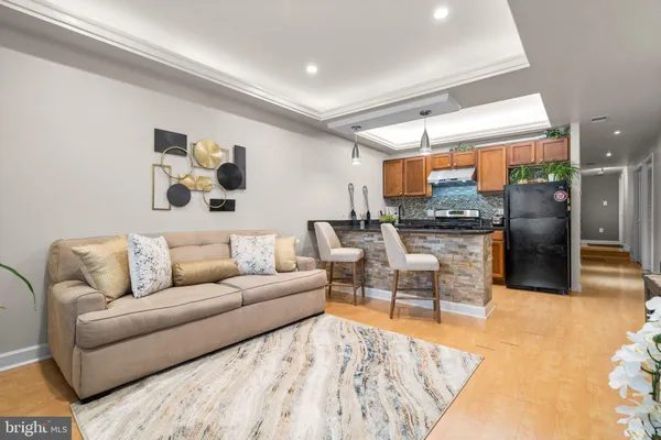 a living room with furniture and kitchen view