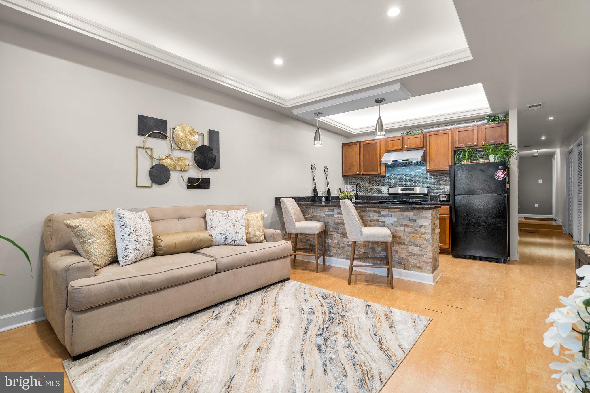 a living room with furniture and kitchen view