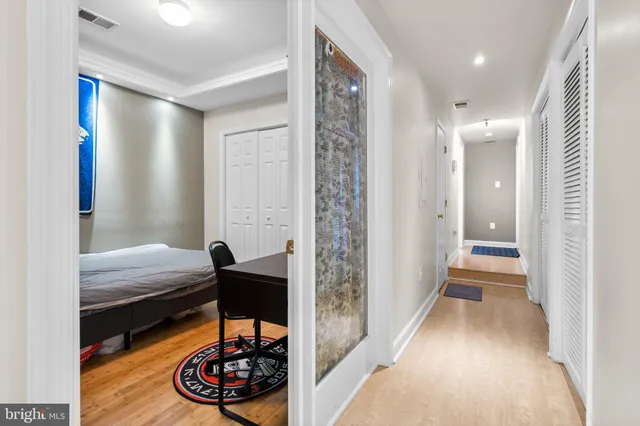 a bedroom with bed and a chandelier