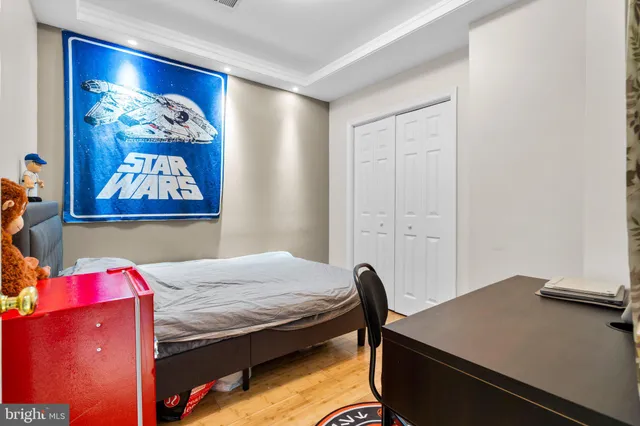 a bedroom with a bed and painting on the wall