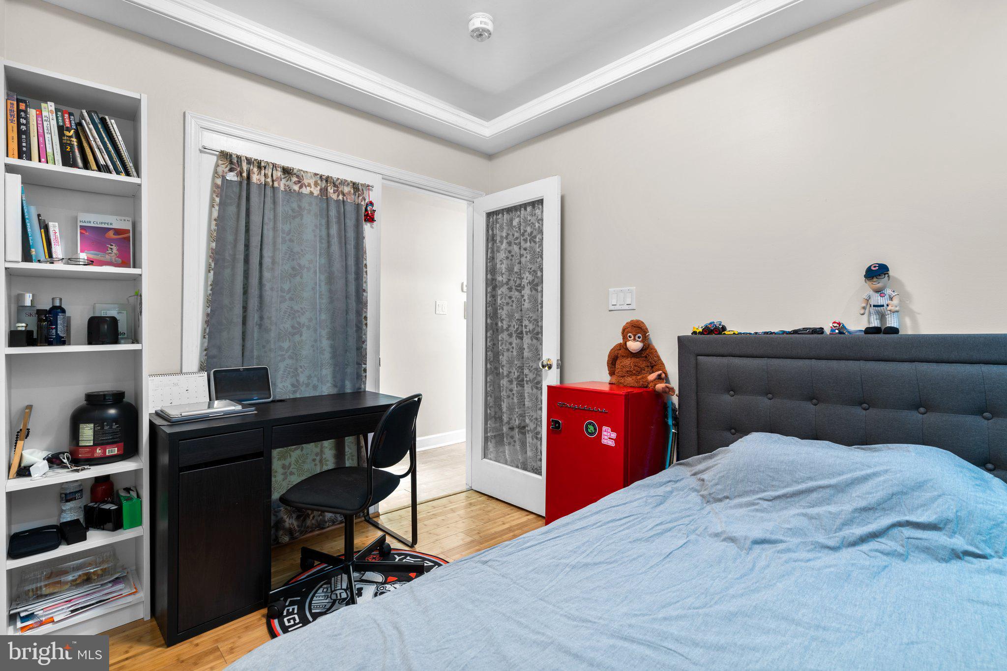 1658 West Virginia Avenue Northeast, Unit 101 Washington, DC 20002 - Photo 14 of 29 a bed room with a bed and a book shelf