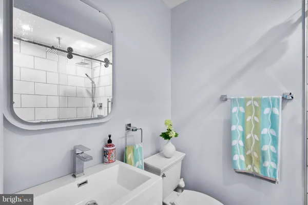 a bathroom with a sink mirror and toilet