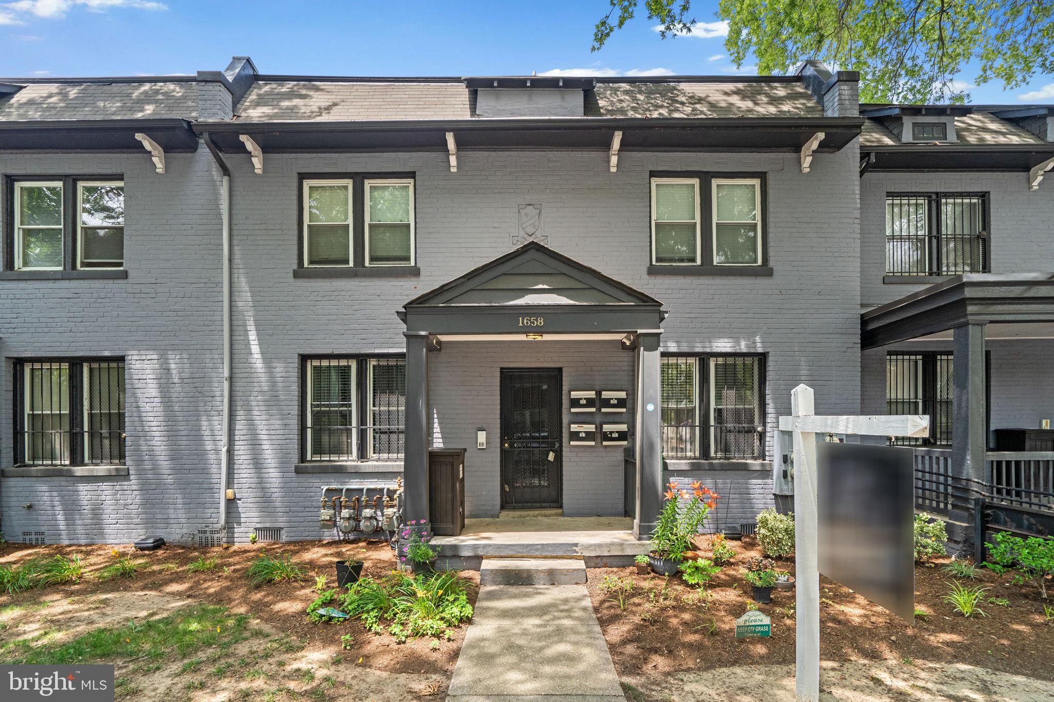 1658 West Virginia Avenue Northeast, Unit 101 Washington, DC 20002 - Photo 26 of 29 a front view of a house with a yard