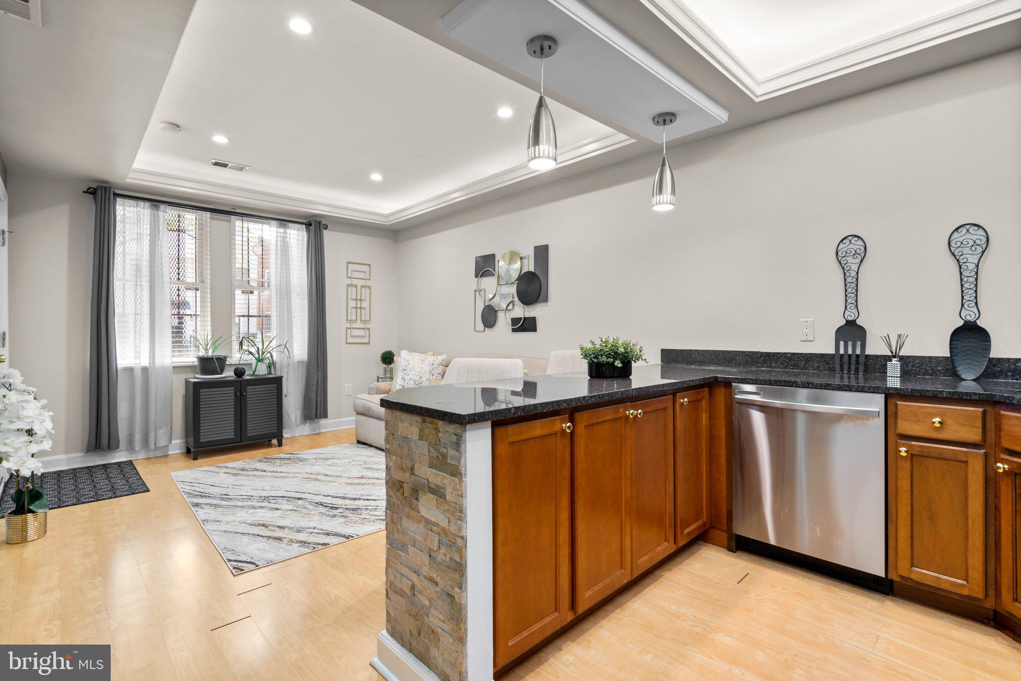 1658 West Virginia Avenue Northeast, Unit 101 Washington, DC 20002 - Photo 9 of 29 a kitchen with stainless steel appliances granite countertop a sink a stove and a refrigerator