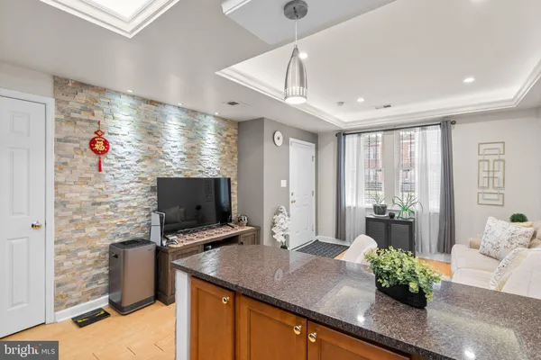 a kitchen with stainless steel appliances granite countertop a sink a stove and a wooden floors