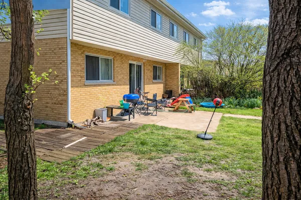 a backyard of a house with table and chairs
