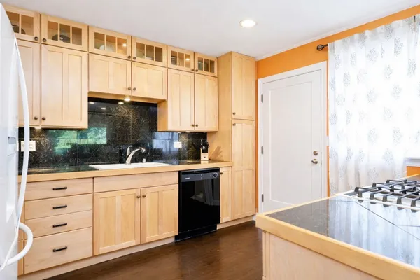 a kitchen with stainless steel appliances granite countertop a refrigerator and a stove top oven