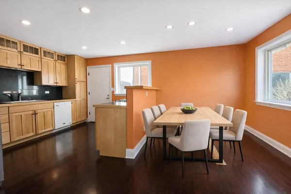 a view of a dining room with furniture and wooden floor