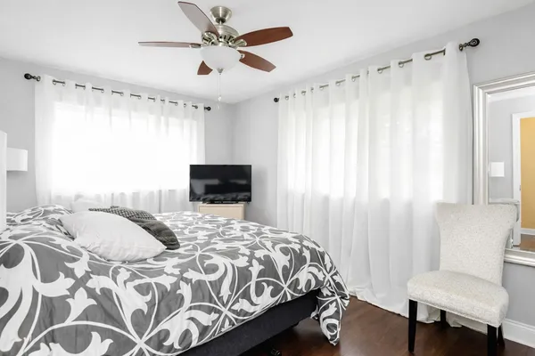 a bedroom with a bed and a chair