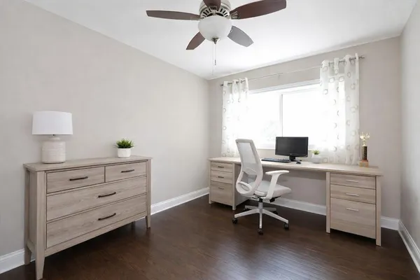 a view of a workspace with furniture and a window
